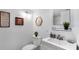 Bright bathroom featuring a toilet, sink, and decor at 701 S Madison Ave # 414, Clearwater, FL 33756