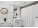A clean and simple bathroom with shower and white cabinets for storage at 701 S Madison Ave # 414, Clearwater, FL 33756