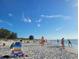 Scenic beach view with people enjoying the sunny weather and clear blue sky at 701 S Madison Ave # 414, Clearwater, FL 33756