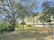 Exterior of building with view of lawn and trees at 701 S Madison Ave # 414, Clearwater, FL 33756