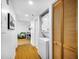 Hallway includes convenient in-unit laundry and a glimpse of the living area with hardwood floors at 701 S Madison Ave # 414, Clearwater, FL 33756