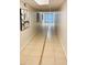 Well-lit hallway showcasing neutral tones and tiled flooring at 701 S Madison Ave # 414, Clearwater, FL 33756