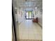 Well-lit hallway with tiled floors, art decorations, and an inviting sofa at 701 S Madison Ave # 414, Clearwater, FL 33756
