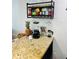 Kitchen area showcasing granite countertop, storage, and a variety of modern appliances at 701 S Madison Ave # 414, Clearwater, FL 33756