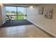 Bright living area featuring large windows, neutral tile flooring, and decorative wall art for an inviting space at 701 S Madison Ave # 414, Clearwater, FL 33756