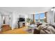 Open-concept living room boasts hardwood floors, large window, and comfortable seating at 701 S Madison Ave # 414, Clearwater, FL 33756