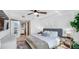 Bright main bedroom with ceiling fan, decorations, and an ensuite bathroom at 701 S Madison Ave # 414, Clearwater, FL 33756