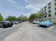 Open parking lot with ample space, surrounded by mature trees and building at 701 S Madison Ave # 414, Clearwater, FL 33756