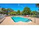 Community pool surrounded by trees and colorful pool chairs at 701 S Madison Ave # 414, Clearwater, FL 33756