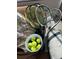 Tennis gear including rackets and tennis balls sit on a comfortable lounge at 701 S Madison Ave # 414, Clearwater, FL 33756