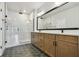 Bathroom with double vanity, large mirror, and glass-enclosed shower at 7236 Sutton Ln, Sarasota, FL 34240