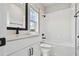 Modern bathroom features a white vanity, black fixtures, and white subway tile at 7236 Sutton Ln, Sarasota, FL 34240