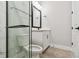 Modern bathroom with a glass shower enclosure, white vanity, and matte black fixtures at 7236 Sutton Ln, Sarasota, FL 34240