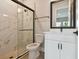 Modern bathroom features a glass enclosed shower and white vanity with matte black fixtures at 7236 Sutton Ln, Sarasota, FL 34240
