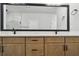 Bathroom with double sink vanity, black hardware, and large framed mirror at 7236 Sutton Ln, Sarasota, FL 34240