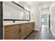 Bathroom featuring a dual sink vanity with black fixtures and a large mirror at 7236 Sutton Ln, Sarasota, FL 34240