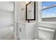 Bright bathroom features a black framed mirror, white vanity, and natural light at 7236 Sutton Ln, Sarasota, FL 34240