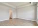 Spacious bedroom with wood-look floors and view of an adjacent bathroom at 7236 Sutton Ln, Sarasota, FL 34240