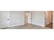 Bedroom with wood-look flooring, light gray walls, and a glimpse of walk-in closet at 7236 Sutton Ln, Sarasota, FL 34240