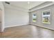 Bright bedroom featuring two windows offering exterior views and wood-look floors at 7236 Sutton Ln, Sarasota, FL 34240