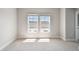 Bright bedroom features plush carpeting, neutral walls, and large windows at 7236 Sutton Ln, Sarasota, FL 34240