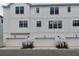 New townhome exterior featuring a modern white facade and three-car garages at 7236 Sutton Ln, Sarasota, FL 34240