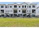 Stunning new construction featuring a modern, bright facade with balconies and professional landscaping at 7236 Sutton Ln, Sarasota, FL 34240