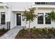Inviting front entryway with meticulously landscaped beds and a charming walkway at 7236 Sutton Ln, Sarasota, FL 34240
