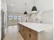 Open-concept kitchen features a large island with a wine cooler, stainless steel appliances, and modern pendant lighting at 7236 Sutton Ln, Sarasota, FL 34240
