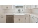 Bright kitchen with farmhouse sink, stainless steel appliances, and sleek white cabinetry at 7236 Sutton Ln, Sarasota, FL 34240