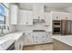 Modern kitchen with white cabinets, stainless steel appliances, farmhouse sink, and stylish backsplash at 7236 Sutton Ln, Sarasota, FL 34240