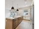 Bright kitchen with a large island, stainless steel appliances, and hardwood floors, creating an inviting space at 7236 Sutton Ln, Sarasota, FL 34240