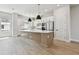 Spacious kitchen features modern island, stainless steel appliances, white cabinets, and ample counter space at 7236 Sutton Ln, Sarasota, FL 34240