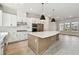 Open kitchen with a large center island, modern stainless appliances, and hardwood floors at 7236 Sutton Ln, Sarasota, FL 34240