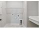 Functional laundry room with white shelving and utility sink for added convenience at 7236 Sutton Ln, Sarasota, FL 34240