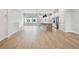 Spacious open-concept living and dining area with hardwood floors and a modern kitchen in the background at 7236 Sutton Ln, Sarasota, FL 34240
