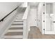 Modern staircase with wooden treads and white risers leading to the upper level at 7236 Sutton Ln, Sarasota, FL 34240