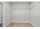Walk-in closet with wire shelving on all sides and wood-look floors at 7236 Sutton Ln, Sarasota, FL 34240