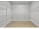A large walk-in closet with plenty of wire shelving and wood-look floors at 7236 Sutton Ln, Sarasota, FL 34240