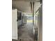 Covered patio with a concrete floor, access to the backyard, and a white refrigerator at 7401 N Albany Ave, Tampa, FL 33604