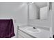 Simple bathroom featuring a white sink, mirror, and a soft purple towel at 7505 Pitch Pine Cir # 122, Tampa, FL 33617
