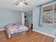 Bedroom featuring wood-look flooring, ceiling fan, bed, and access to walk-in closet at 7505 Pitch Pine Cir # 122, Tampa, FL 33617