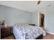 Comfortable bedroom with wood floors, large window, and access to closet and bathroom at 7505 Pitch Pine Cir # 122, Tampa, FL 33617