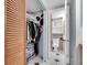 Well-organized closet with shelving, hanging racks, and door opening to a nearby bathroom at 7505 Pitch Pine Cir # 122, Tampa, FL 33617