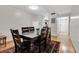 Dining area with table for six, wood flooring, and access to the kitchen at 7505 Pitch Pine Cir # 122, Tampa, FL 33617