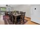 Dining area features wood table with seating for six, situated on top of a decorative rug at 7505 Pitch Pine Cir # 122, Tampa, FL 33617