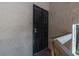 Close-up of condo entry with decorative wrought iron security door and stucco exterior at 7505 Pitch Pine Cir # 122, Tampa, FL 33617