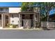 Condo exterior shows two-story building with tan stucco, shaded entry, and Fire Lane painted on the asphalt at 7505 Pitch Pine Cir # 122, Tampa, FL 33617