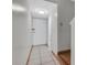 Condo hallway with tile floors and neutral paint, showcasing entry door and staircase at 7505 Pitch Pine Cir # 122, Tampa, FL 33617
