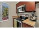 Efficient kitchen with stainless steel microwave, smooth cooktop, and a bright window view at 7505 Pitch Pine Cir # 122, Tampa, FL 33617